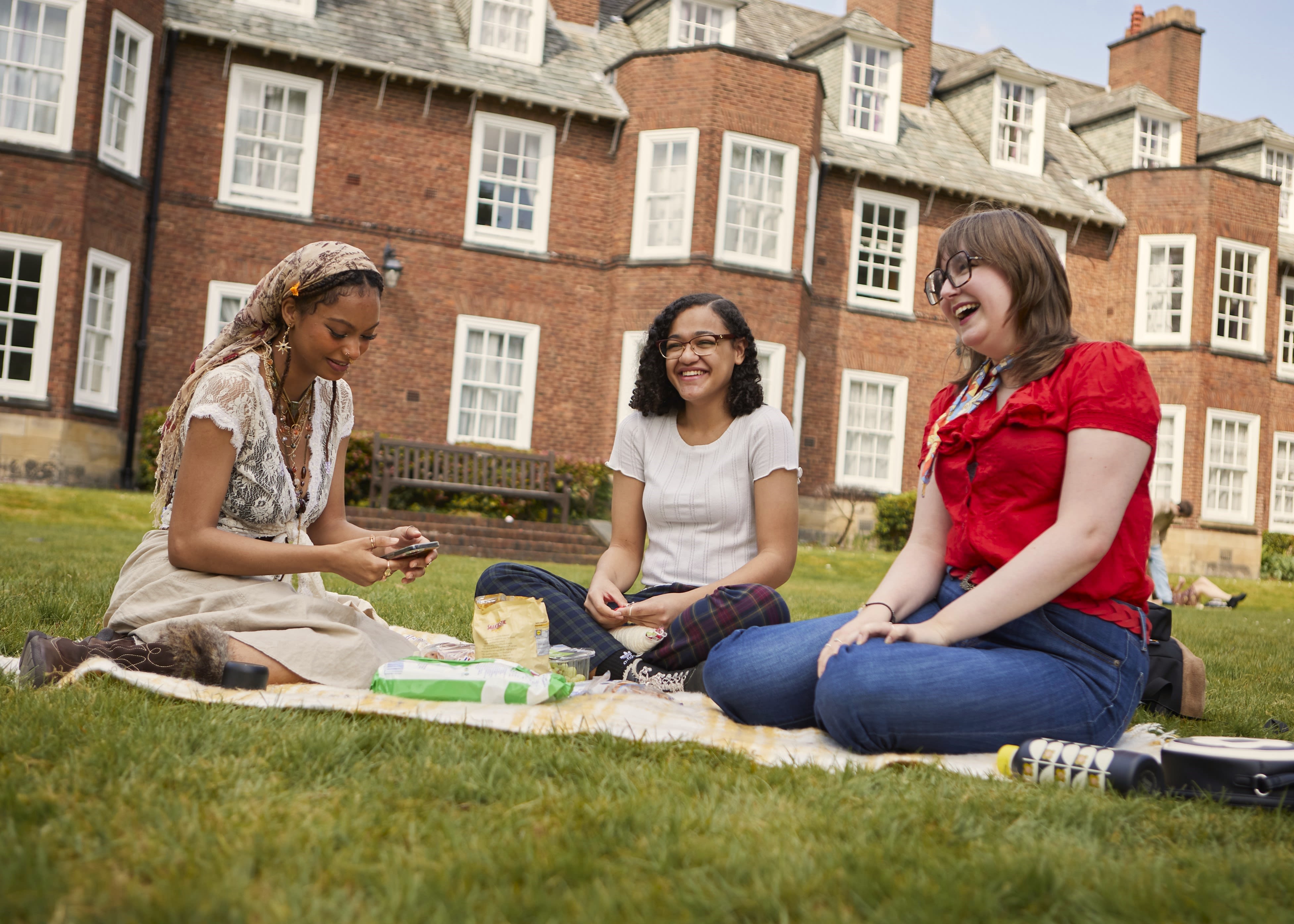 Three women speaking and laughing